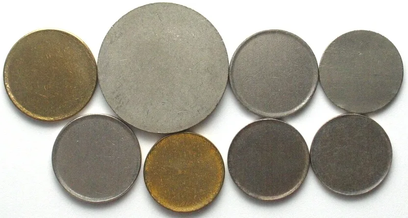 1920-1990 8 base metal planchets for international coins 1920-1990 UNC